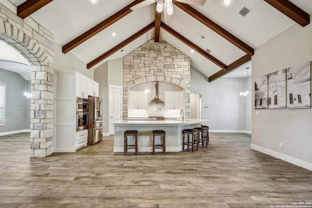 1609 Havenwood, New Braunfels, TX 78132 - kitchen with visible vents, arched walkways, ceiling fan, and white cabinetry