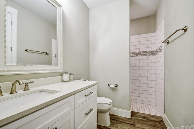1609 Havenwood, New Braunfels, TX 78132 - full bath featuring vanity, toilet, baseboards, tiled shower, and wood finished floors