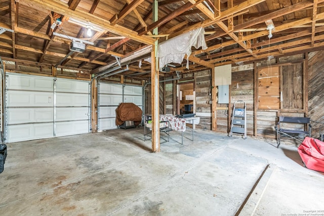 garage featuring a garage door opener and electric panel