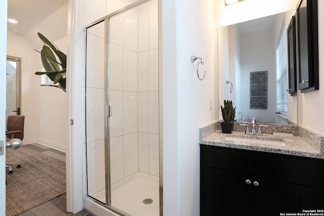 bathroom with vanity and a stall shower