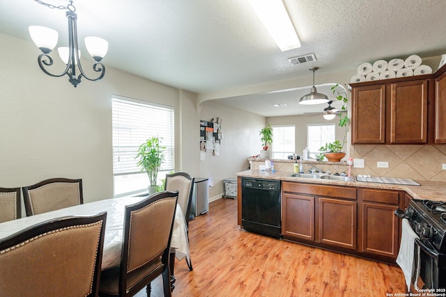 kitchen with visible vents, tasteful backsplash, light wood-style floors, black appliances, and brown cabinetry