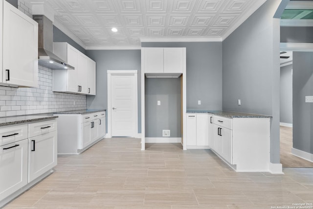 129 Cincinnati, San Antonio, TX 78201 - kitchen featuring wall chimney range hood, an ornate ceiling, tasteful backsplash, and dark stone counters