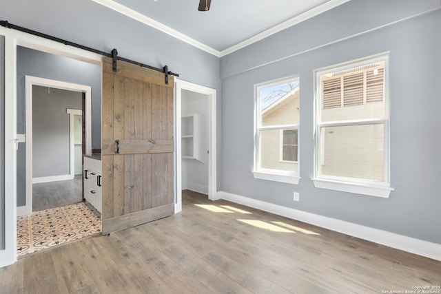 129 Cincinnati, San Antonio, TX 78201 - empty room with baseboards, ornamental molding, wood finished floors, a ceiling fan, and a barn door