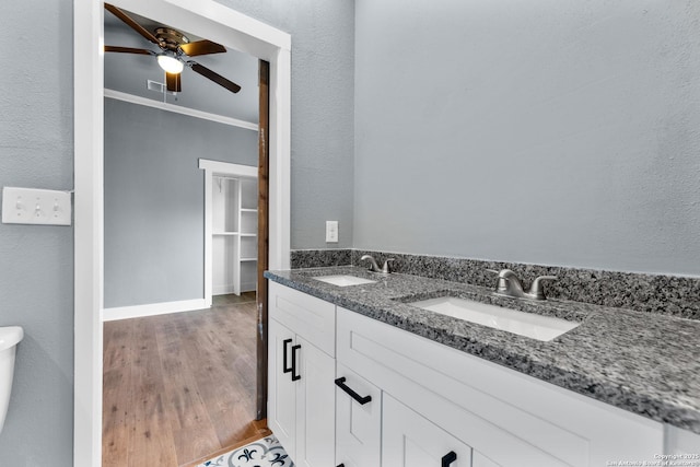 129 Cincinnati, San Antonio, TX 78201 - bathroom featuring a ceiling fan, a sink, double vanity, and wood finished floors