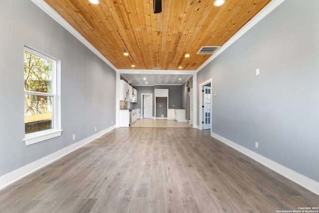 129 Cincinnati, San Antonio, TX 78201 - unfurnished living room featuring baseboards, crown molding, wooden ceiling, and recessed lighting