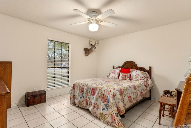 bedroom featuring baseboards, a ceiling fan, and light tile patterned floors
