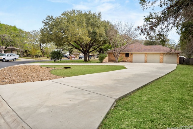 exterior space featuring a front lawn, driveway, and a garage