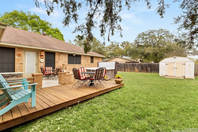 wooden terrace featuring outdoor dining area, a fenced backyard, a storage unit, a lawn, and an outdoor structure