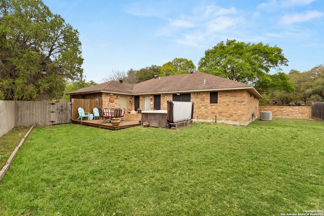 rear view of property with central AC, a fenced backyard, a lawn, and a deck