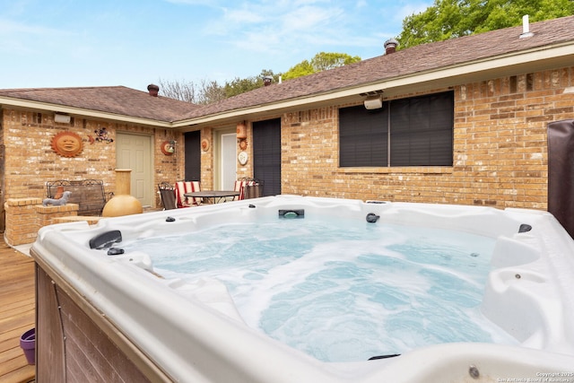 exterior space with a hot tub