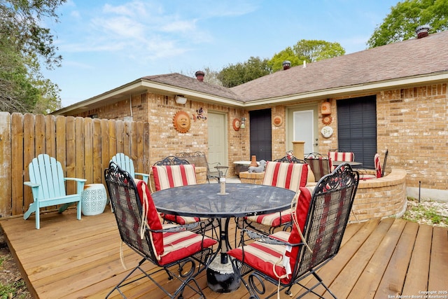 wooden deck featuring outdoor dining area and fence