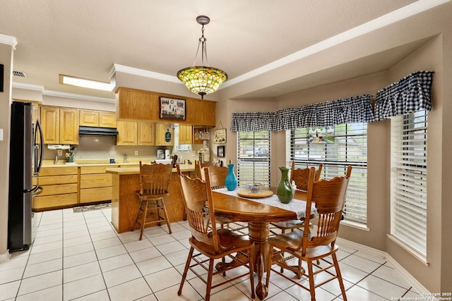 dining space with baseboards, visible vents, crown molding, and light tile patterned floors