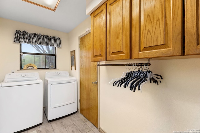 laundry room featuring cabinet space, washer and dryer, and light wood finished floors
