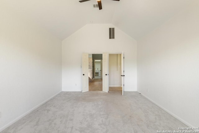 spare room with high vaulted ceiling, baseboards, carpet floors, ceiling fan, and visible vents
