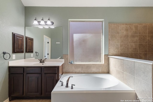 bathroom featuring vanity and a bath