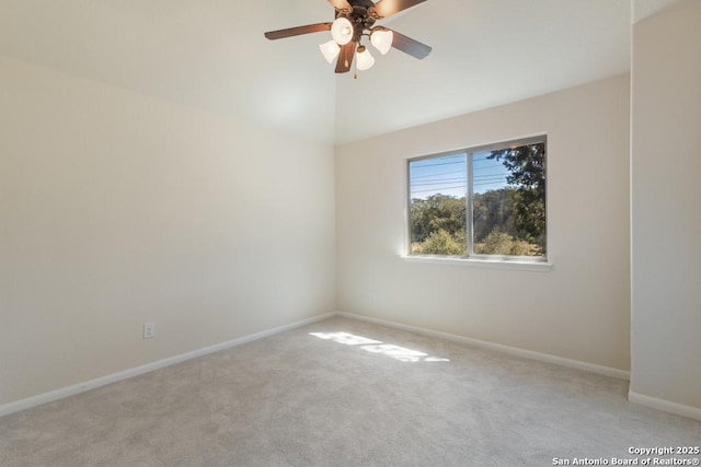 unfurnished room featuring a ceiling fan, baseboards, and light colored carpet