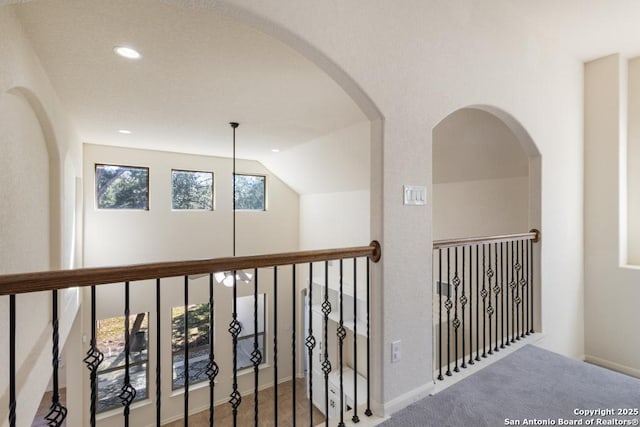 corridor featuring vaulted ceiling and recessed lighting