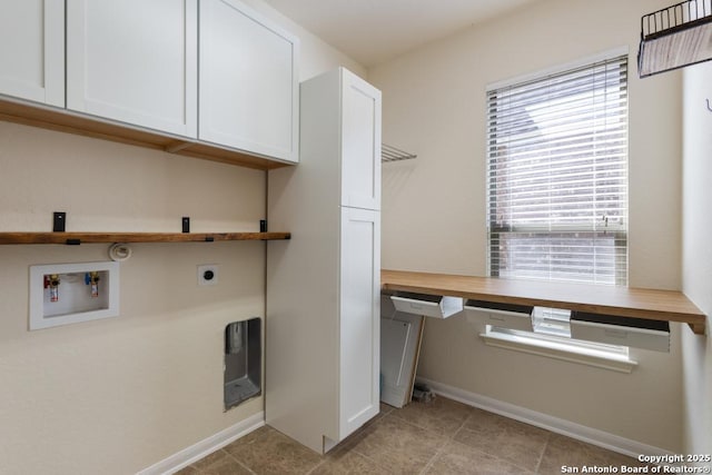 laundry room featuring hookup for an electric dryer, light tile patterned floors, baseboards, cabinet space, and washer hookup