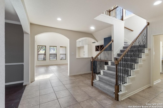 stairway featuring tile patterned flooring, baseboards, and recessed lighting