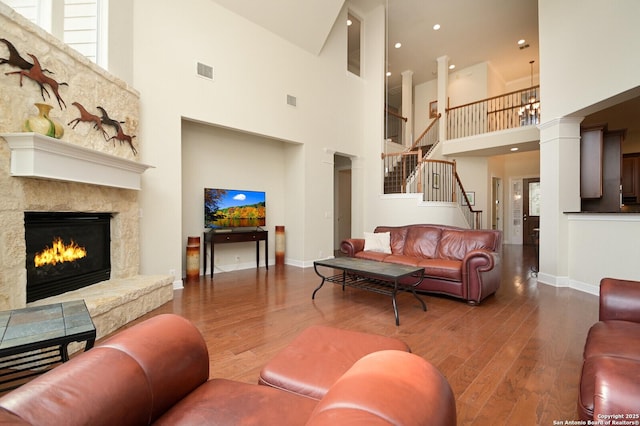 4630 Grass Fight, San Antonio, TX 78253 - living area featuring stairway, a fireplace, wood finished floors, baseboards, and visible vents