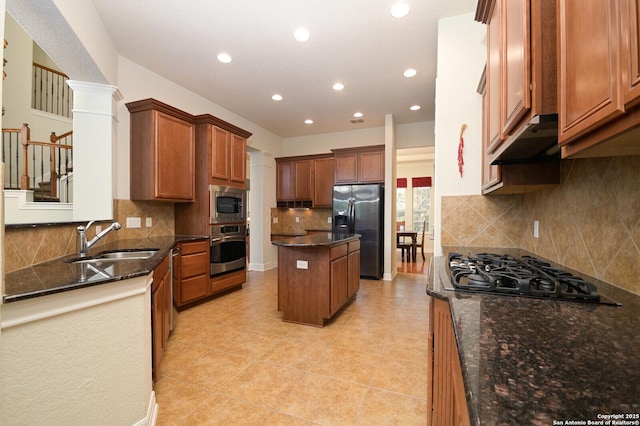 4630 Grass Fight, San Antonio, TX 78253 - kitchen featuring stainless steel appliances, under cabinet range hood, dark stone counters, a kitchen island, and a sink