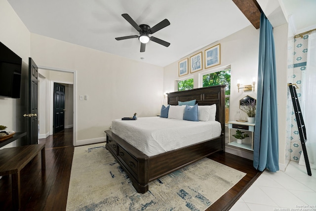 bedroom with baseboards, ceiling fan, and wood finished floors