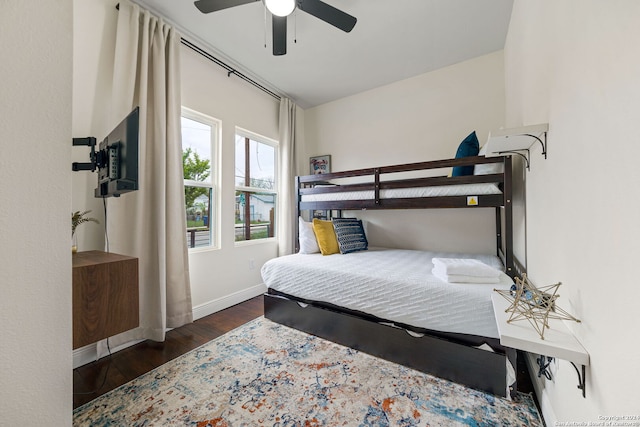 bedroom featuring baseboards, ceiling fan, and wood finished floors