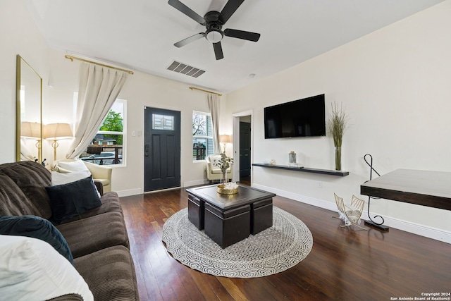living room with wood-type flooring, baseboards, ceiling fan, and visible vents
