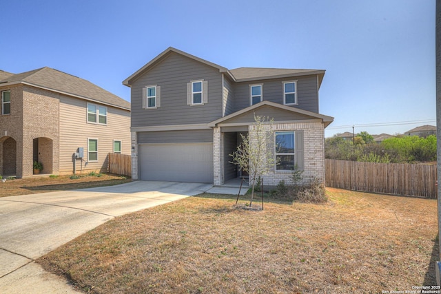 traditional-style home with brick siding, concrete driveway, fence, and an attached garage
