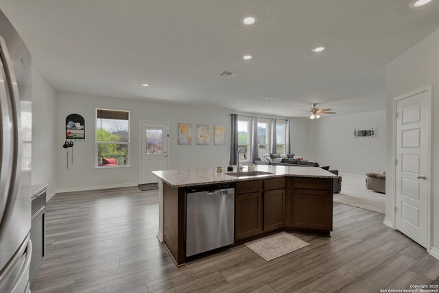 kitchen featuring visible vents, appliances with stainless steel finishes, a sink, a healthy amount of sunlight, and open floor plan