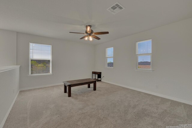 rec room featuring carpet floors, visible vents, a ceiling fan, and plenty of natural light