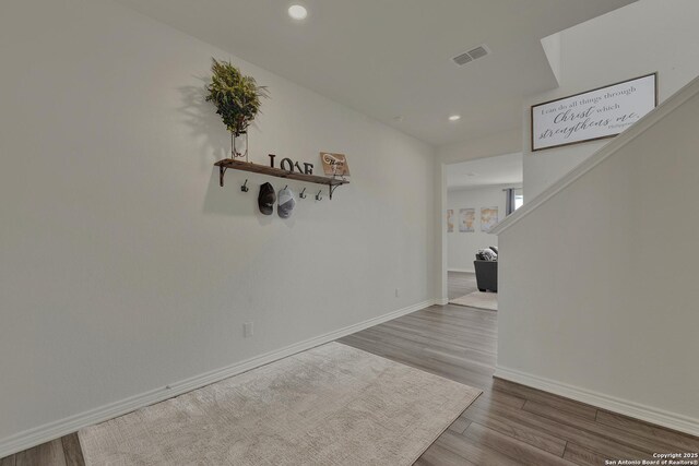 hall with stairway, recessed lighting, baseboards, visible vents, and wood finished floors