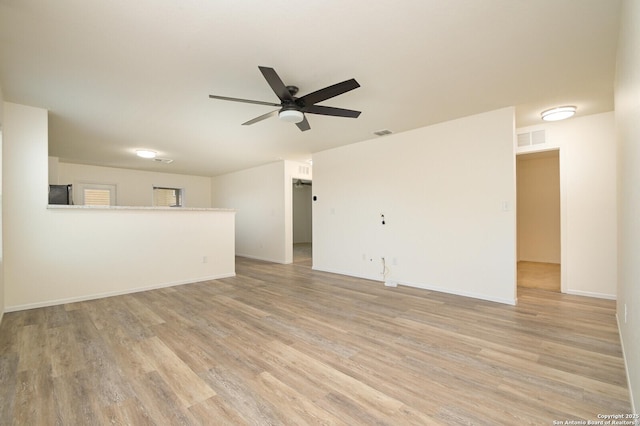 180 Elderberry, New Braunfels, TX 78130 - unfurnished living room featuring a ceiling fan, light wood-style floors, and visible vents