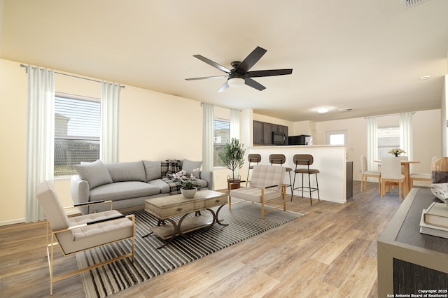 180 Elderberry, New Braunfels, TX 78130 - living room with baseboards, light wood-style flooring, a ceiling fan, and plenty of natural light
