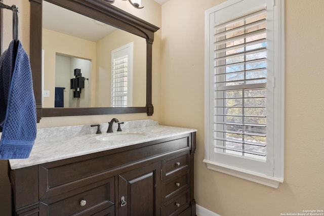 bathroom with vanity and baseboards