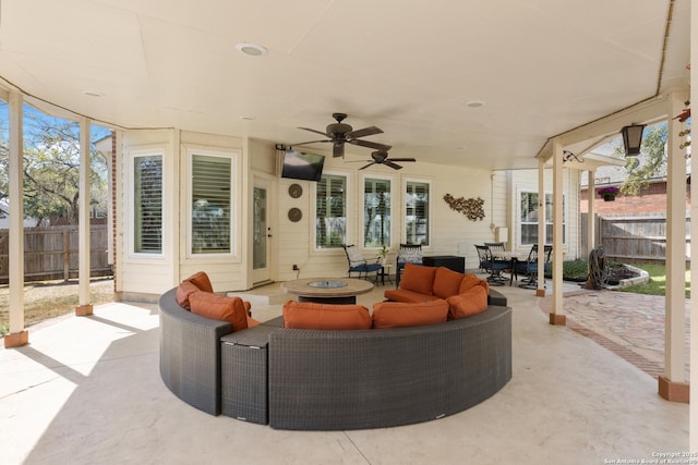 view of patio with outdoor dining area, an outdoor hangout area, fence, and ceiling fan