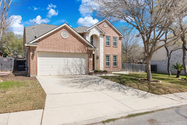 traditional-style house featuring cooling unit, concrete driveway, fence, brick siding, and a garage