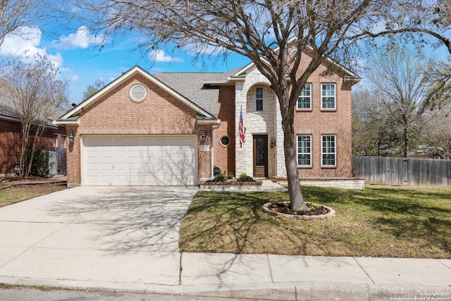 traditional-style home with driveway, a front yard, fence, brick siding, and a garage