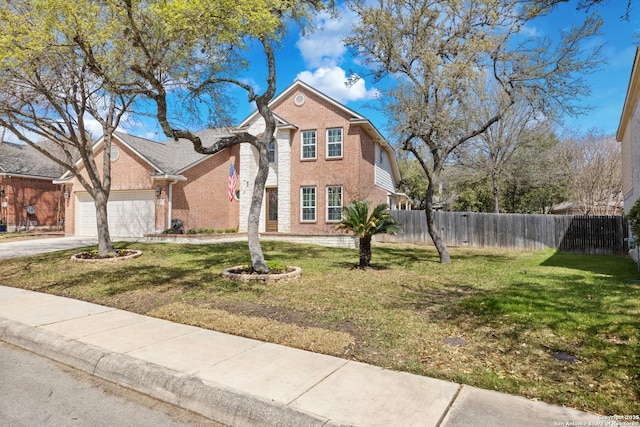 traditional-style home featuring a front yard, fence, brick siding, and a garage