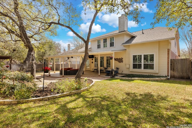 back of house with a patio area, a ceiling fan, a chimney, fence, and a yard