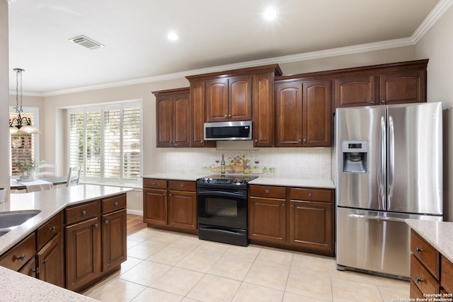 kitchen with visible vents, backsplash, crown molding, and appliances with stainless steel finishes
