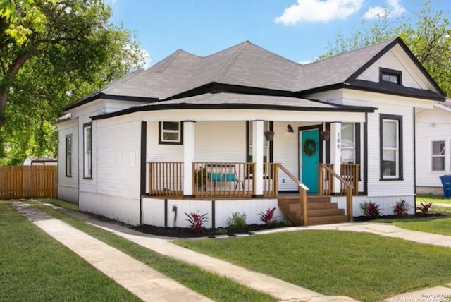 144 Ward Ave, San Antonio, TX 78223 - bungalow featuring a front lawn, covered porch, and fence