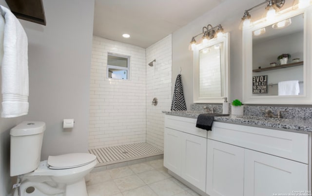 144 Ward Ave, San Antonio, TX 78223 - bathroom featuring toilet, vanity, tile patterned floors, and a tile shower