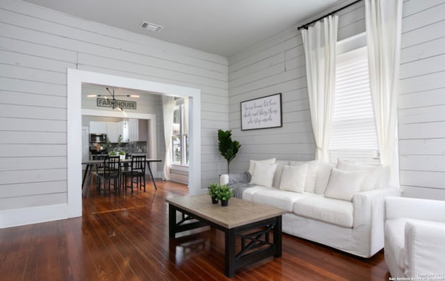 144 Ward Ave, San Antonio, TX 78223 - living room with an inviting chandelier, dark wood-type flooring, baseboards, and visible vents
