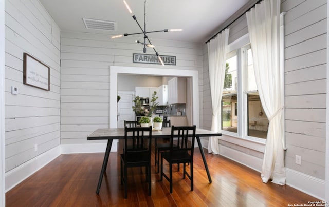 144 Ward Ave, San Antonio, TX 78223 - dining space with baseboards, visible vents, a notable chandelier, and dark wood-type flooring