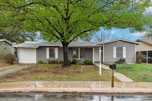 single story home with driveway and a garage