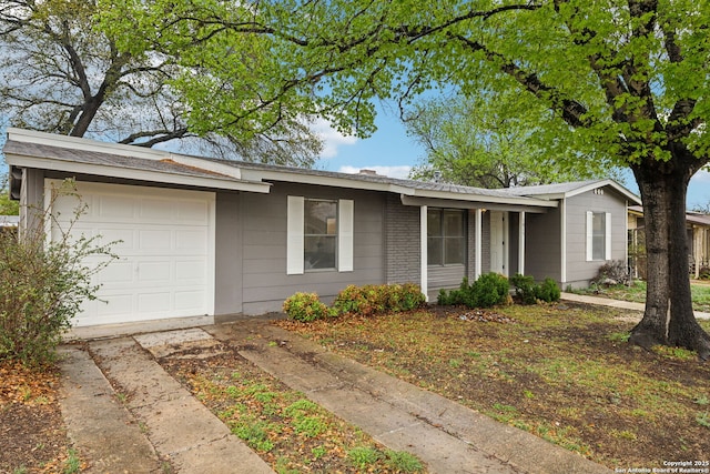 ranch-style house with driveway and an attached garage
