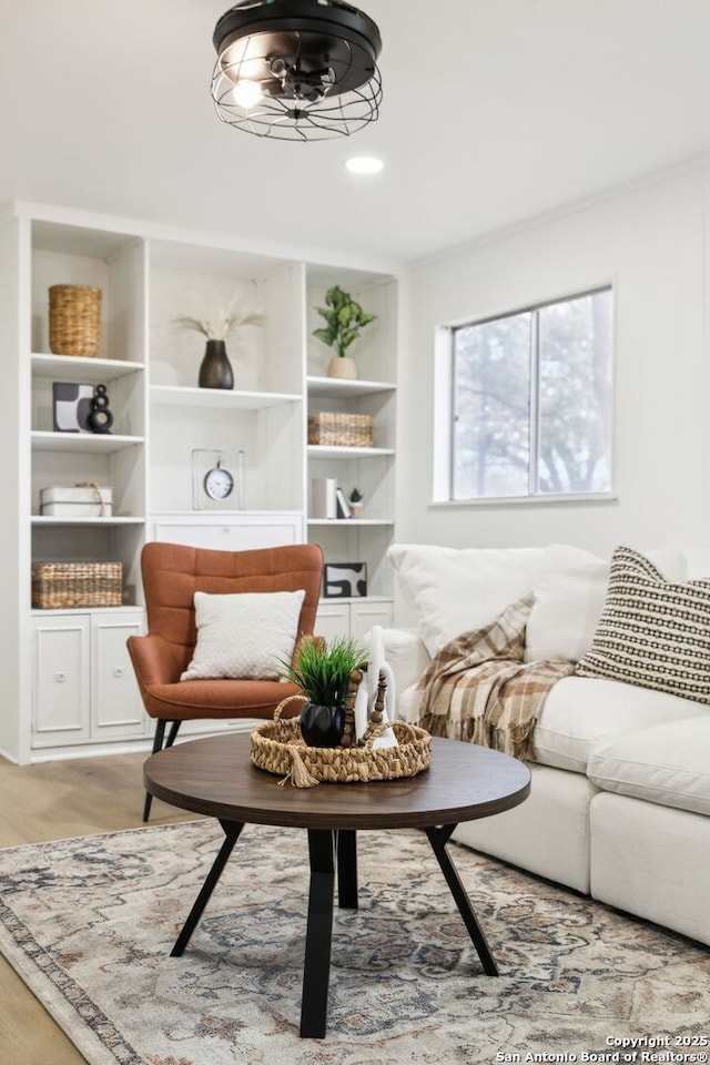 sitting room featuring crown molding and light wood-type flooring