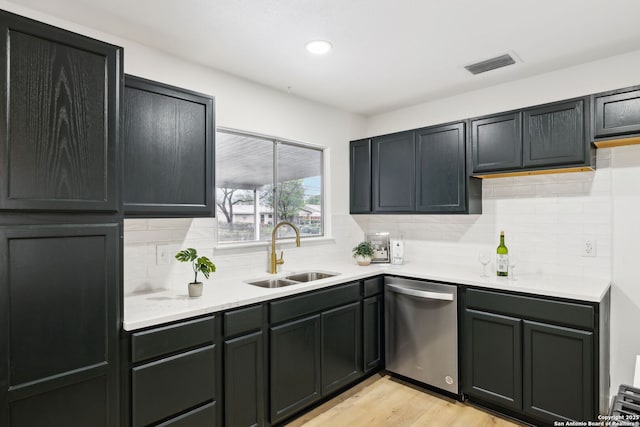 kitchen with light countertops, visible vents, light wood-style flooring, dishwasher, and a sink