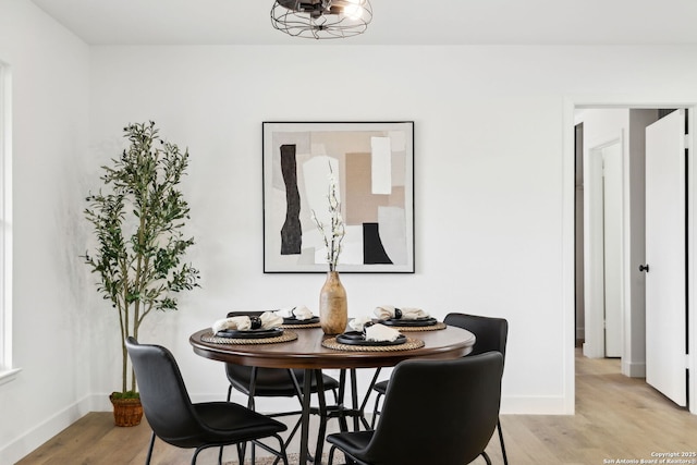 dining room featuring baseboards and light wood-type flooring